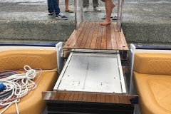 Platform Lift on a Speedboat Extended to Marina