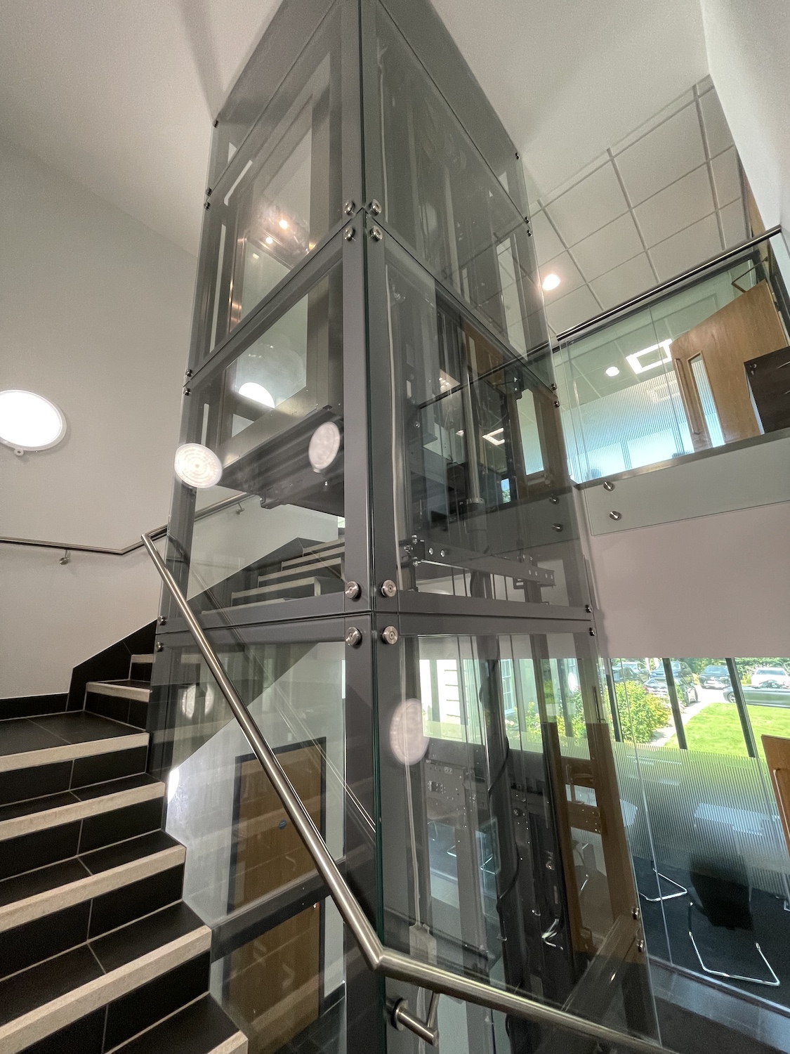 The lift features a custom made handrail which is fixed through the glass onto the lift's steel frame