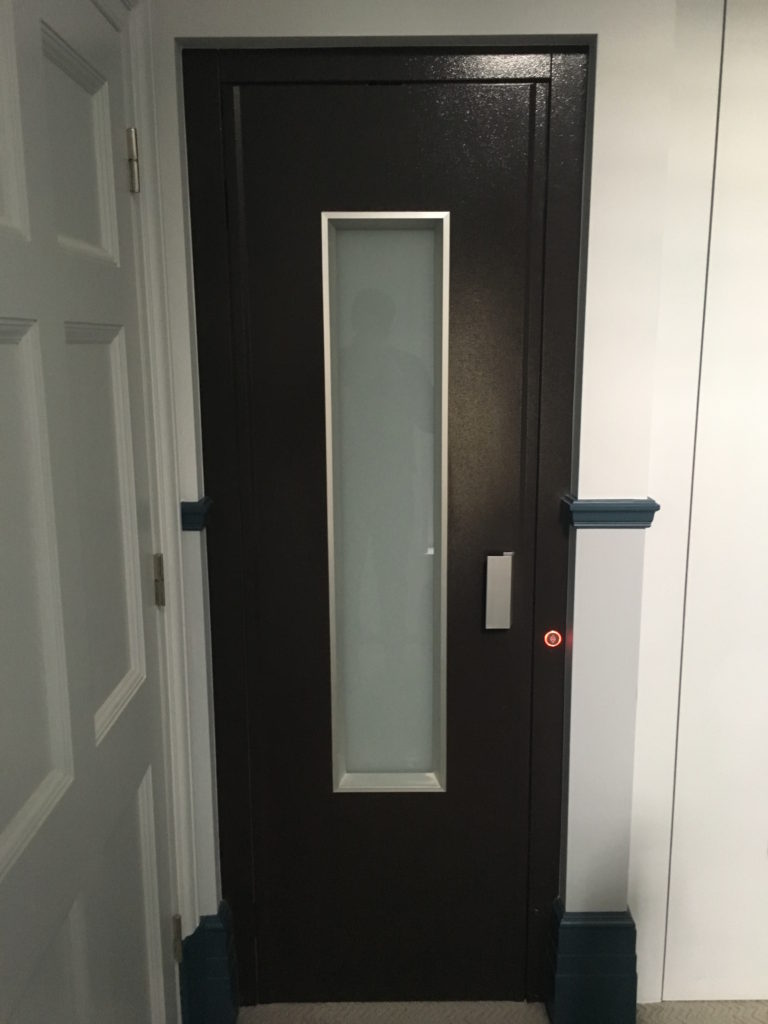 Glass and steel door in dark grey in apartment block in Mount Street, London