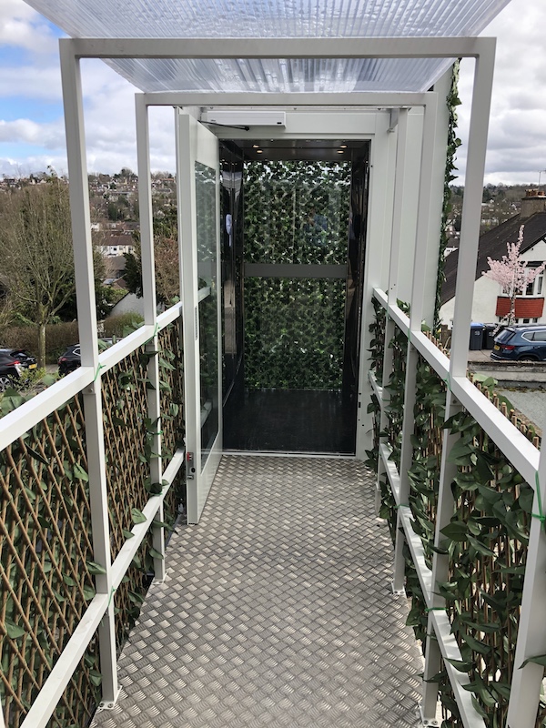Walkway leading to the lift in South Croydon with polished stainless steel cabin