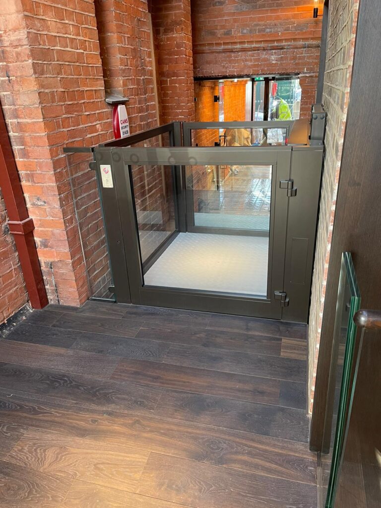 The open platform lift colour matches steelwork found around the museum